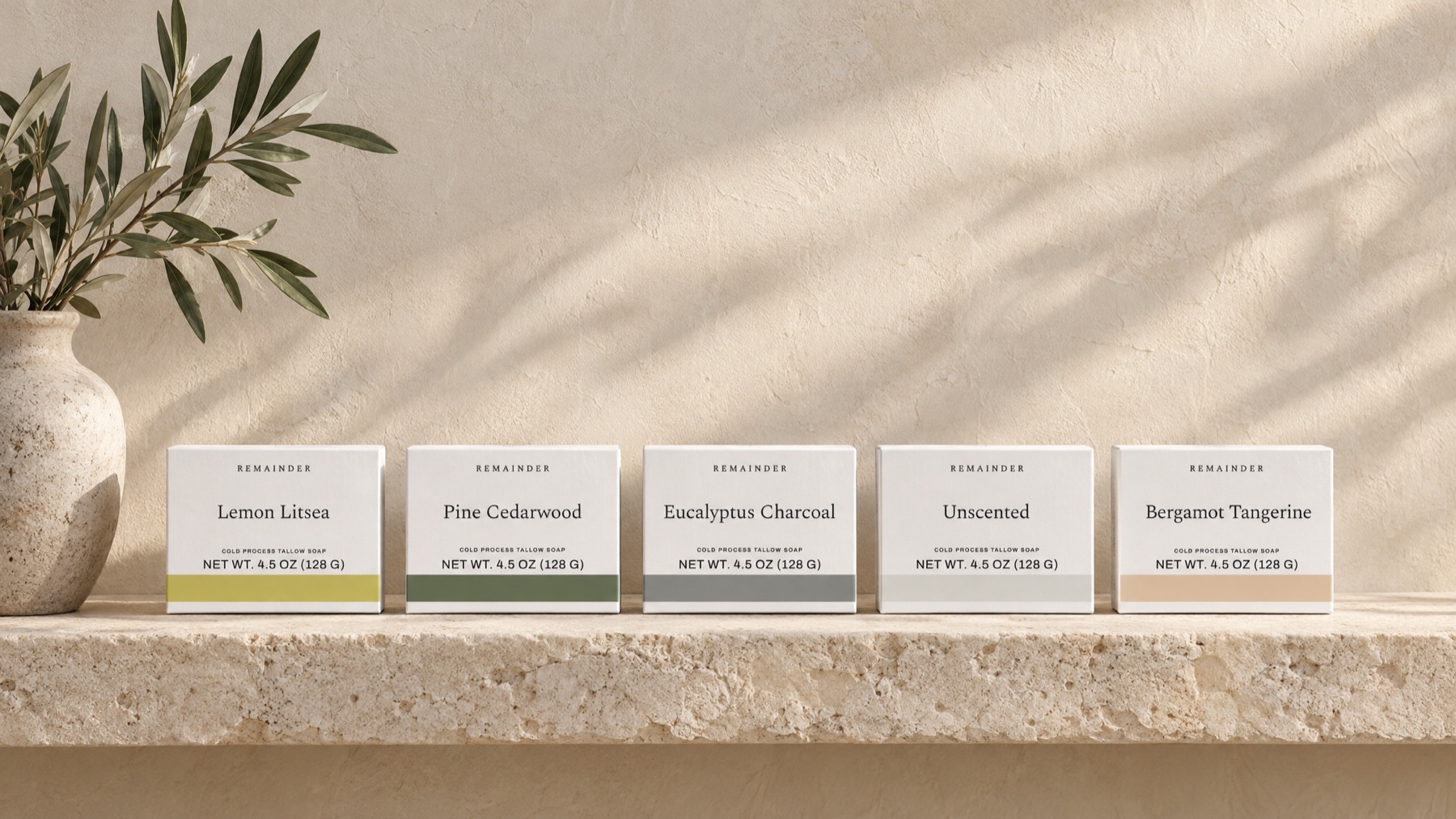 Five Remainder soap boxes on a limestone ledge against limewash plaster